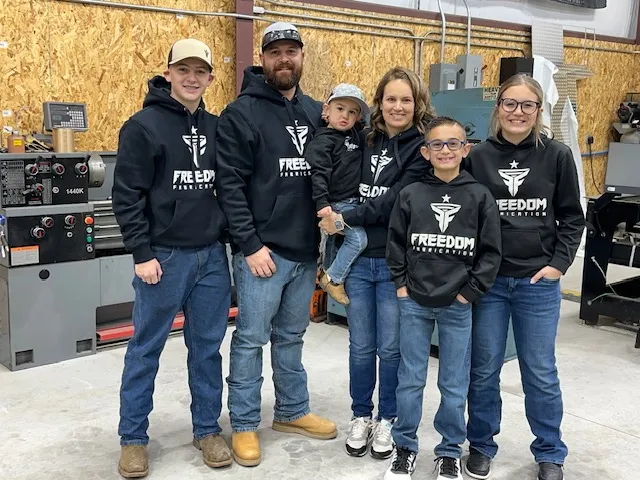 The Freedom Fabrication family team wearing Freedom Fabrication hoodies