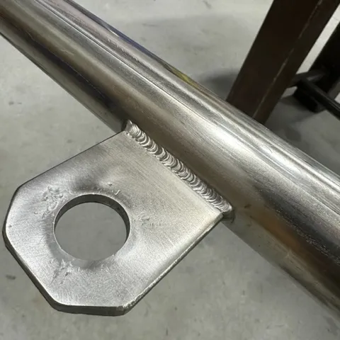 Close-up of a welded steel bracket and tab